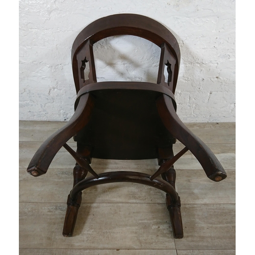 220B - An early 20th century elm and beech captains desk chair with later added blue vinyl upholstery