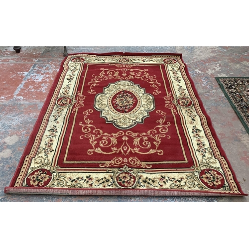 226A - A Turkish Tapiso Atlas red ground machine woven rug - approx. 243cm x 180cm