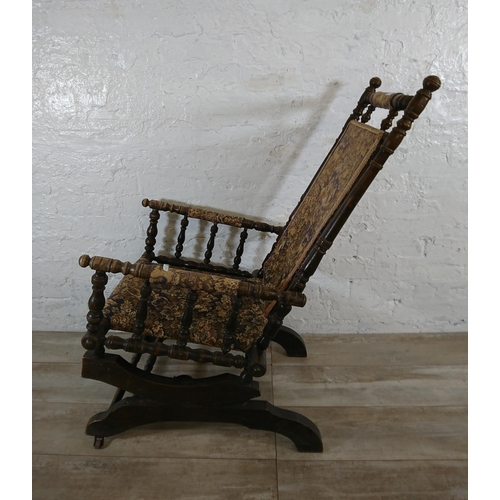 227 - An early 20th century American beech and tapestry upholstered rocking chair