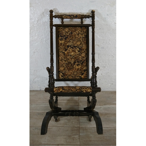 227 - An early 20th century American beech and tapestry upholstered rocking chair