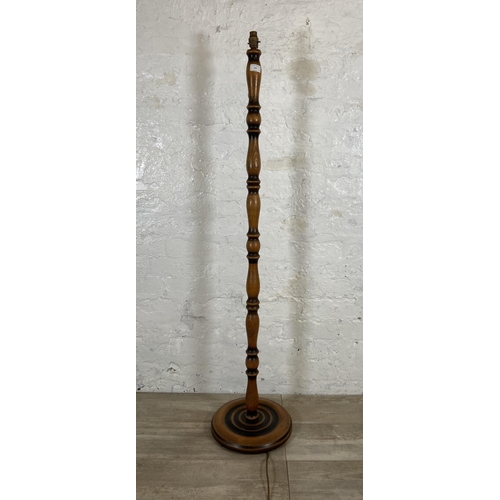 234 - A beech standard lamp with circular base - approx. 140cm high