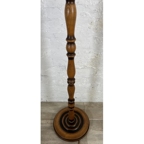 234 - A beech standard lamp with circular base - approx. 140cm high