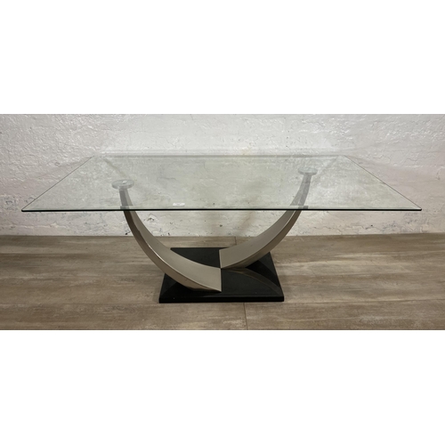 235 - A modern glass top coffee table on metal pedestal base - approx. 47cm high x 71cm wide x 126cm long