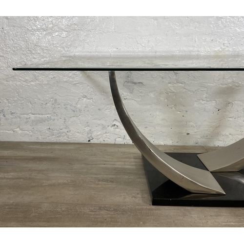 235 - A modern glass top coffee table on metal pedestal base - approx. 47cm high x 71cm wide x 126cm long