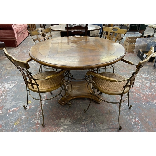 235A - A pine and wrought metal circular dining table and four rattan seated chairs - approx. 75cm high x 1... 