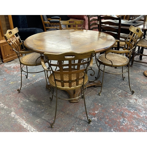 235A - A pine and wrought metal circular dining table and four rattan seated chairs - approx. 75cm high x 1... 