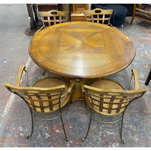 235A - A pine and wrought metal circular dining table and four rattan seated chairs - approx. 75cm high x 1... 