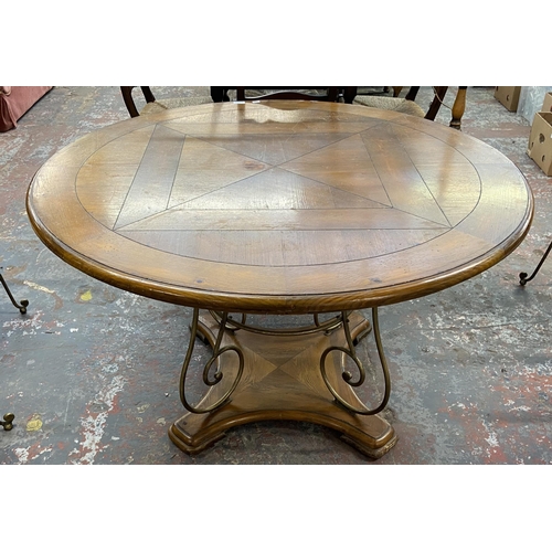 235A - A pine and wrought metal circular dining table and four rattan seated chairs - approx. 75cm high x 1... 