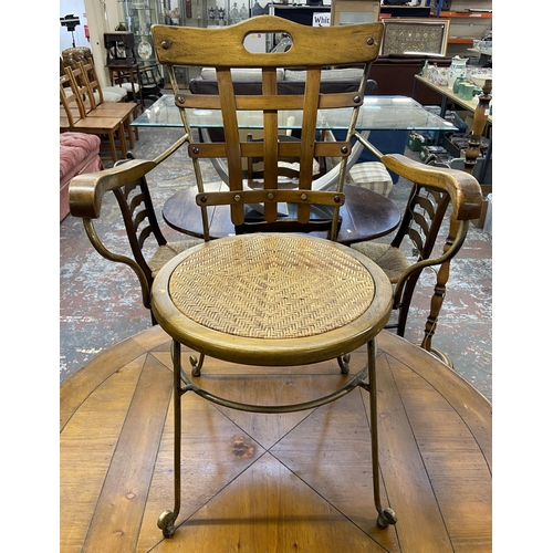 235A - A pine and wrought metal circular dining table and four rattan seated chairs - approx. 75cm high x 1... 