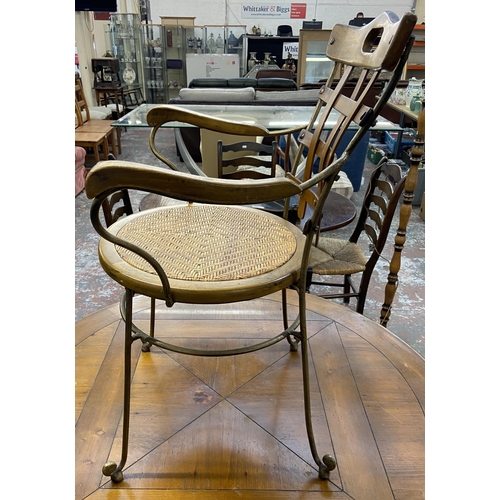 235A - A pine and wrought metal circular dining table and four rattan seated chairs - approx. 75cm high x 1... 