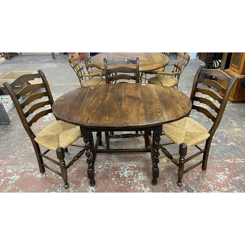 236 - An early 20th century oak drop leaf barley twist dining table and four 19th century style beech and ... 