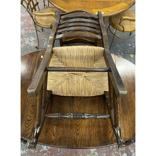 236 - An early 20th century oak drop leaf barley twist dining table and four 19th century style beech and ... 