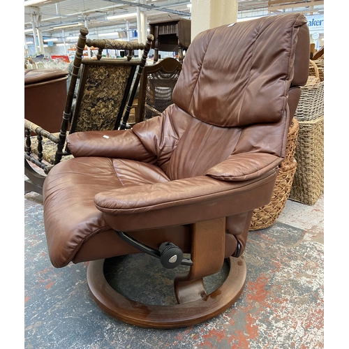 242A - An Ekornes Stressless cognac brown leather and beech swivel reclining armchair and footstool