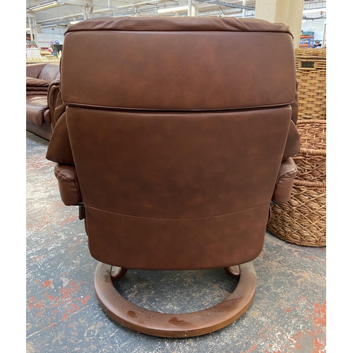 242A - An Ekornes Stressless cognac brown leather and beech swivel reclining armchair and footstool