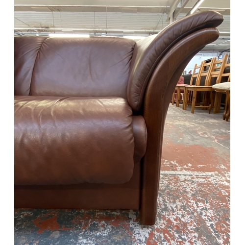 242B - An Ekornes stressless cognac brown leather and beech three seater sofa with new seat cushion