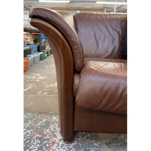 242B - An Ekornes stressless cognac brown leather and beech three seater sofa with new seat cushion