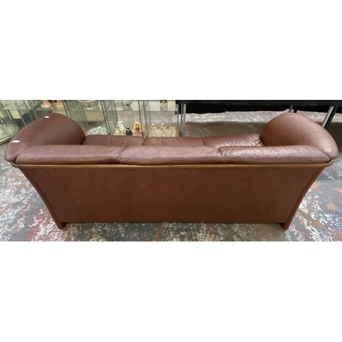 242B - An Ekornes stressless cognac brown leather and beech three seater sofa with new seat cushion