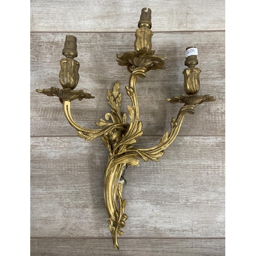 244 - Two pairs of Rococo style gilt metal wall sconces