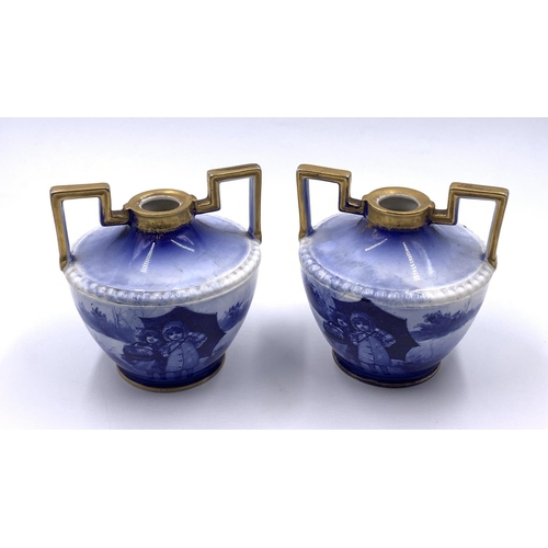 334 - A pair of Royal Doulton Children's Series blue transfer printed and gilded twin handled vases - appr... 