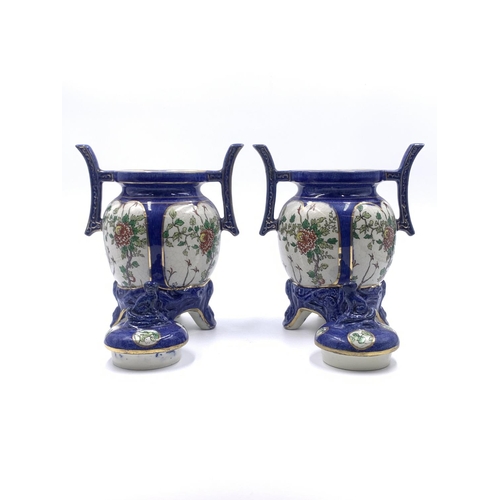 347 - A pair of Oriental hand painted porcelain twin handled ginger jars and covers - approx. 21cm high