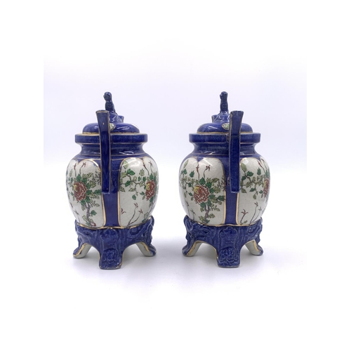 347 - A pair of Oriental hand painted porcelain twin handled ginger jars and covers - approx. 21cm high