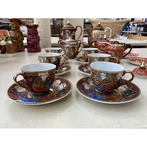 378 - A collection of Japanese Satsuma porcelain to include two coffee pots, eight cups, twelve saucers et... 