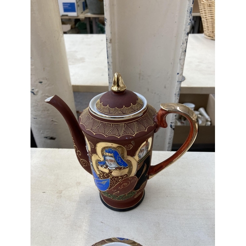 378 - A collection of Japanese Satsuma porcelain to include two coffee pots, eight cups, twelve saucers et... 