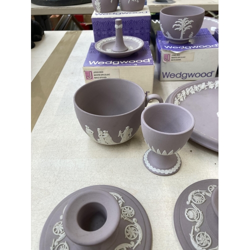 381 - Twelve pieces of Wedgwood lilac Jasperware to include boxed ring stand, boxed fluted candlestick, cu... 