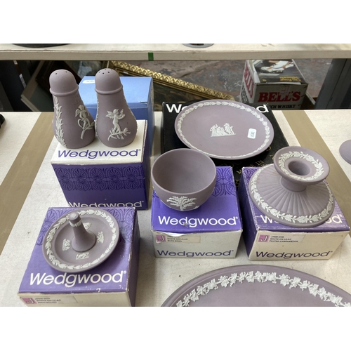 381 - Twelve pieces of Wedgwood lilac Jasperware to include boxed ring stand, boxed fluted candlestick, cu... 