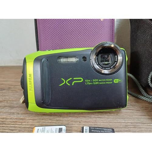 603 - Three cased rugged compact digital cameras, one Fujifilm FinePix XP90 16mp water/shock proof, one Ol... 