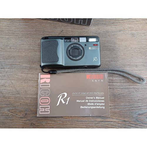 604 - Thirteen boxed cameras to include Ricoh R1 ultra-slim autofocus compact 35mm with instruction manual... 