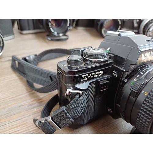 607 - Six Minolta 35mm SLR cameras fitted with Minolta lenses, X-700, SR-7 fitted with Rokkor-PF 1:1.4 f=5... 