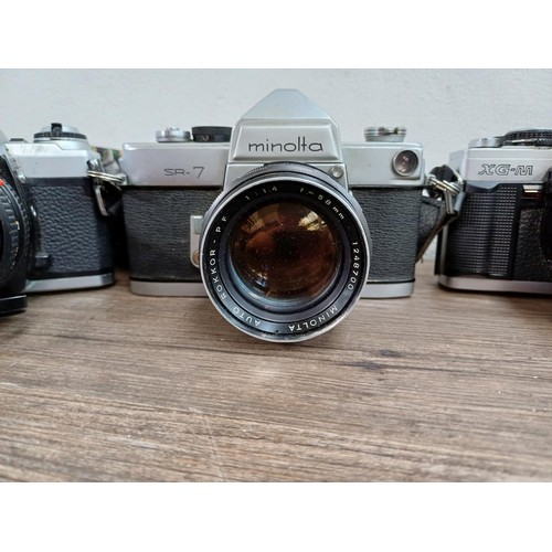 607 - Six Minolta 35mm SLR cameras fitted with Minolta lenses, X-700, SR-7 fitted with Rokkor-PF 1:1.4 f=5... 