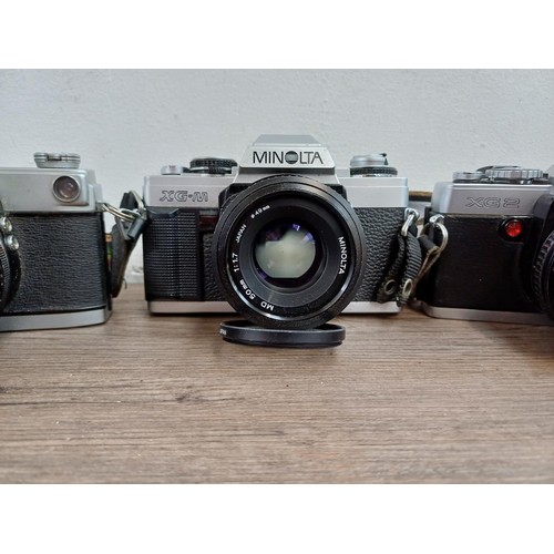 607 - Six Minolta 35mm SLR cameras fitted with Minolta lenses, X-700, SR-7 fitted with Rokkor-PF 1:1.4 f=5... 