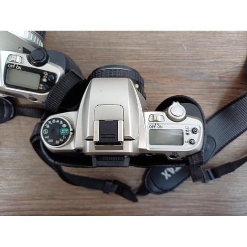 614 - Three Pentax 35mm SLR cameras, one MZ-30 fitted with Pentax-FA 1:4-5.6 35-80mm lens, one MZ-30 fitte... 