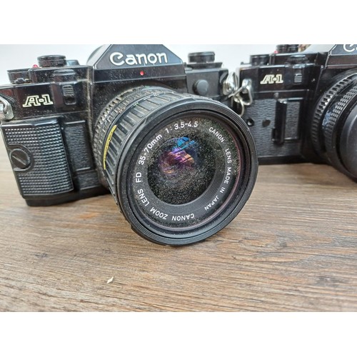 615 - Five Canon A-1 35mm SLR cameras fitted with Canon FD lenses, one 1:1.4 50mm, Power Winder A and Data... 