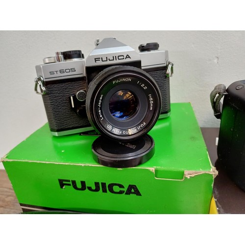 617 - Three boxed 35mm SLR cameras, one cased Fujica ST605 fitted with Fujinon 1:2.2 f=55mm lens with inst... 