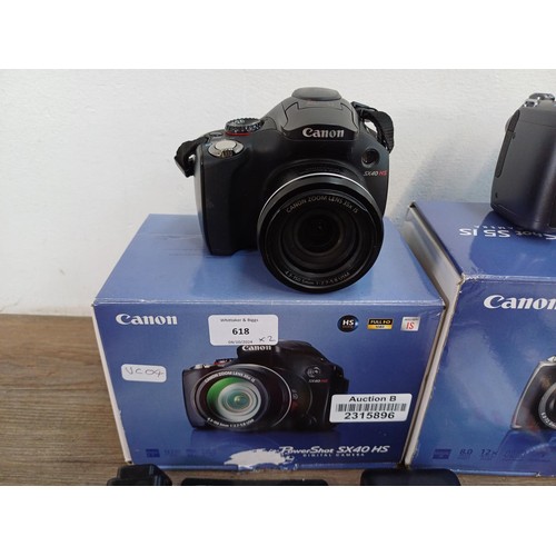 618 - Two boxed Canon PowerShot digital bridge cameras with software discs, SD cards, instruction manuals ... 