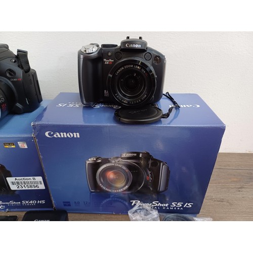 618 - Two boxed Canon PowerShot digital bridge cameras with software discs, SD cards, instruction manuals ... 