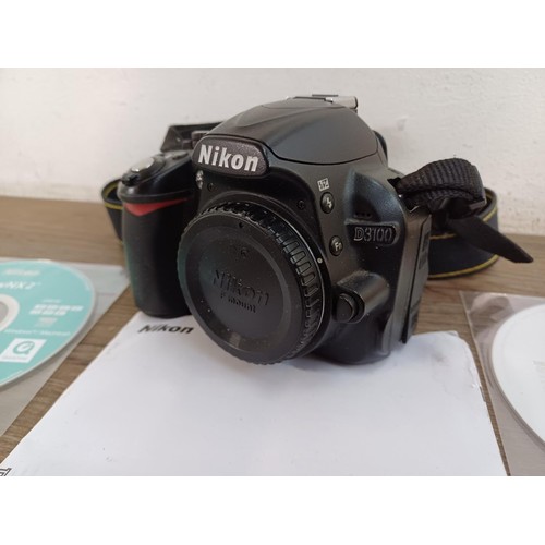 647 - A Nikon D3100 DSLR camera body with charger, software discs and instruction manual