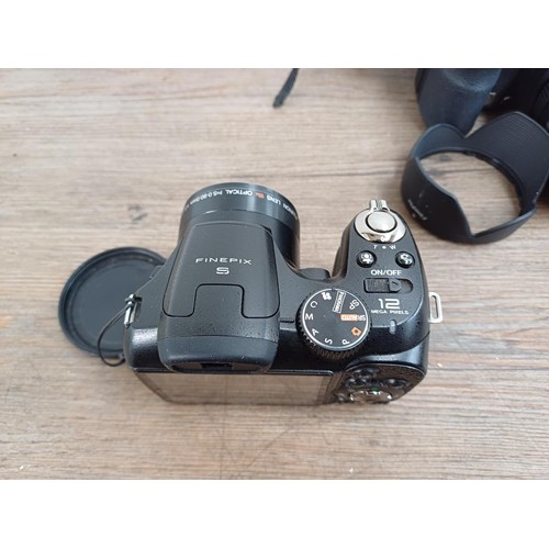 651 - Four Fujifilm FinePix digital bridge cameras, one S1850 12mp, one S9600 9mp, one S5700 7.1mp and one... 