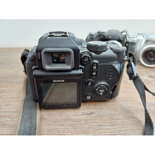 651 - Four Fujifilm FinePix digital bridge cameras, one S1850 12mp, one S9600 9mp, one S5700 7.1mp and one... 