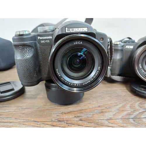 653 - Three Panasonic Lumix digital bridge cameras, one cased FZ38 12mp, one cased FZ10 4mp and one FZ8