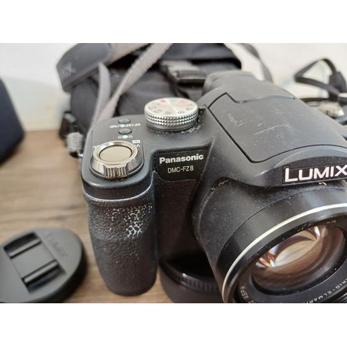 653 - Three Panasonic Lumix digital bridge cameras, one cased FZ38 12mp, one cased FZ10 4mp and one FZ8