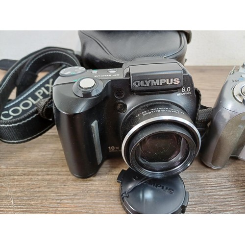 654 - Three digital bridge cameras, one cased Olympus SP-500UZ 6mp, one Nikon Coolpix P510 16.1mp and one ... 