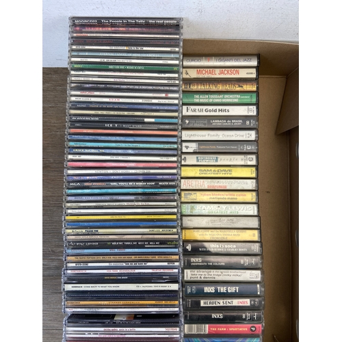 739 - Two Boxes containing CDs and cassettes by a variety of artists and bands to include Oasis, R.E.M, Bo... 