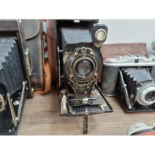 664 - Eleven folding cameras to include Zeiss Ikon Nettar 518/16, Coronet Rapide, Balda Baldix, Agfa Isole... 