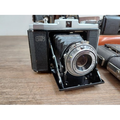 664 - Eleven folding cameras to include Zeiss Ikon Nettar 518/16, Coronet Rapide, Balda Baldix, Agfa Isole... 