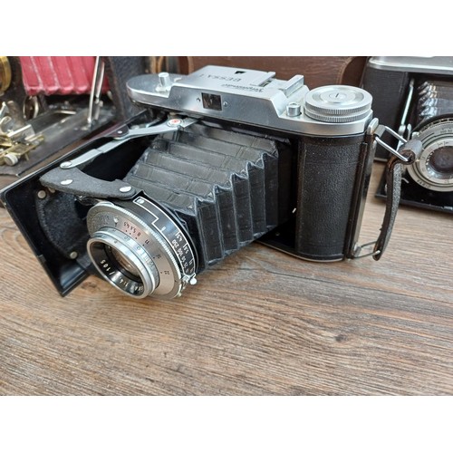 666 - Eight folding cameras to include Voigtländer Bessa I 6x9 viewfinder for 120 film, Agfa Isolette V, K... 