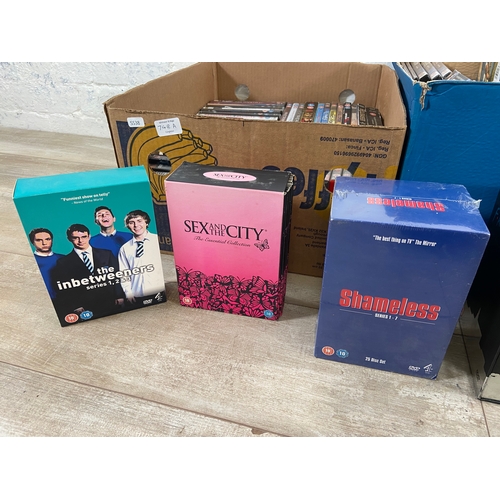 748A - Three boxes of DVDs contains a wide variety of movies and TV shows to include Friends complete serie... 